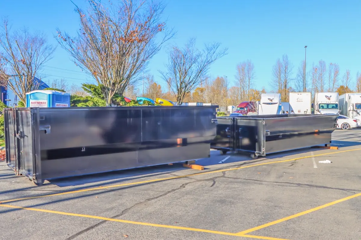 Professional dumpster rental service with roll-off container on residential driveway in Pocono